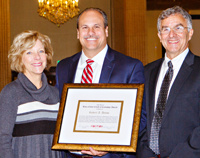 Robert Daino (center) receives the CNY&nbsp;RPDB's Rhea Eckel Clark Citizenship Award from Board Chairwoman Kathleen A. Rapp and Executive Director David V. Bottar at the Board's 2016 Annual Meeting