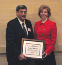 Louis Pettinelli (left) receives the CNY&nbsp;RPDB's Rhea Eckel Clark Citizenship Award from Board Chairwoman Kathleen A. Rapp at the Board's 2010 Annual Meeting