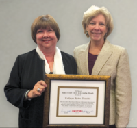 Katheryn Howe Ruscitto (left) receives the CNY&nbsp;RPDB's Rhea Eckel Clark Citizenship Award from Board Chairwoman Kathleen A. Rapp at the Board's 2015 Annual Meeting